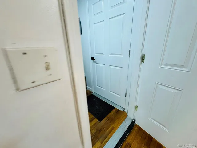 a view of a room with wooden floor and bathroom