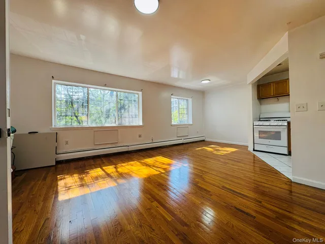 a view of a kitchen with wooden floor and electronic appliances