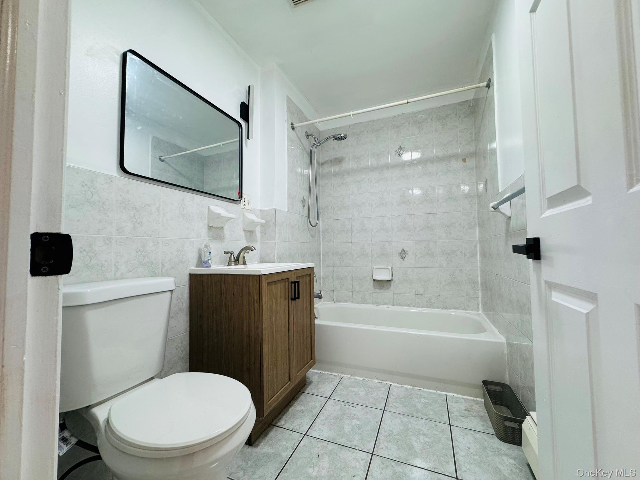 53 West 192nd Street, Unit 3A Bronx, NY 10468 - Photo 3 of 14 a bathroom with a toilet a sink and bathtub