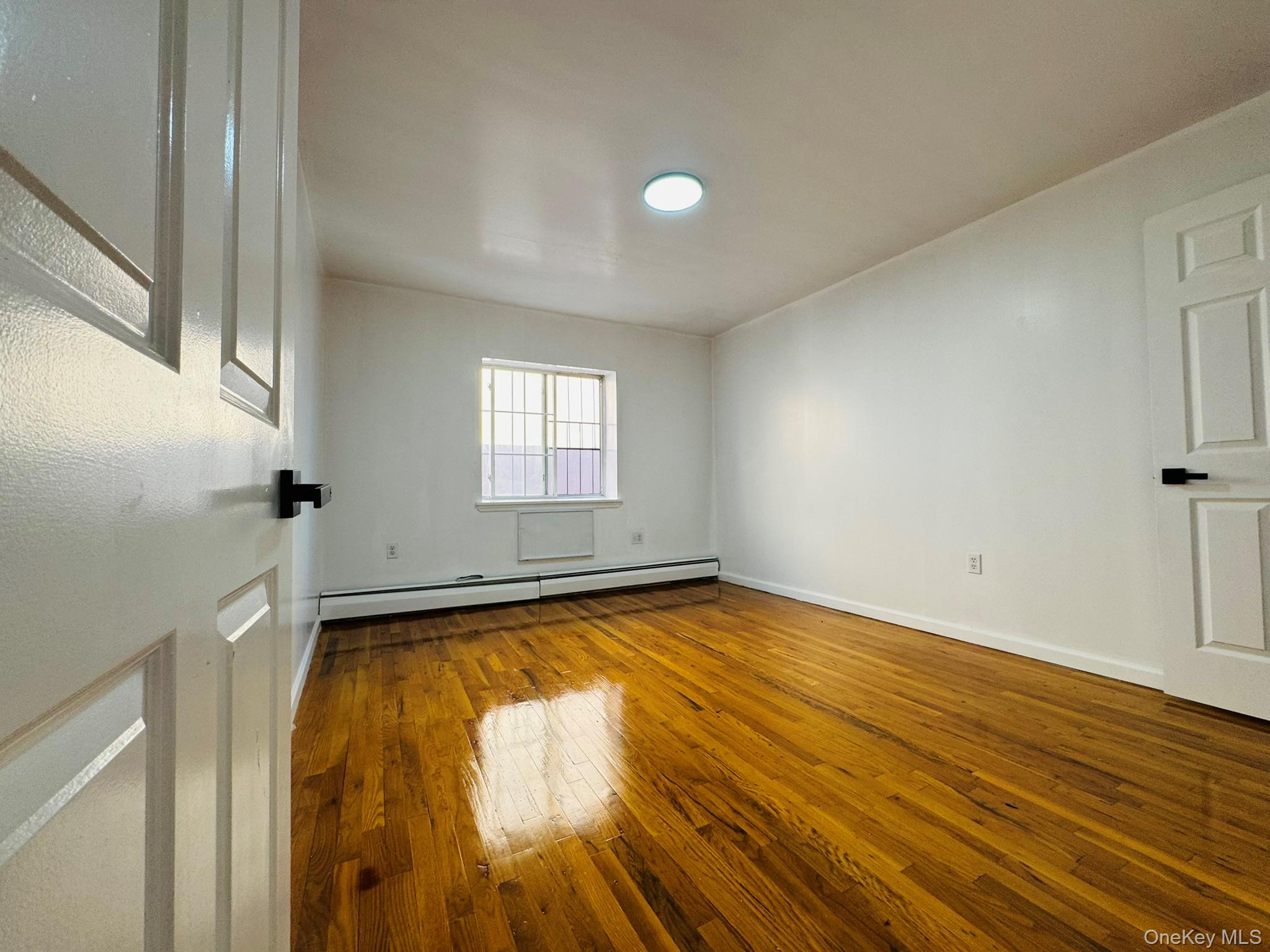 53 West 192nd Street, Unit 3A Bronx, NY 10468 - Photo 4 of 14 a view of a kitchen with a tub and wooden floor