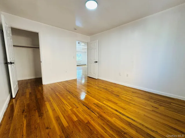 a view of a kitchen with a tub and wooden floor