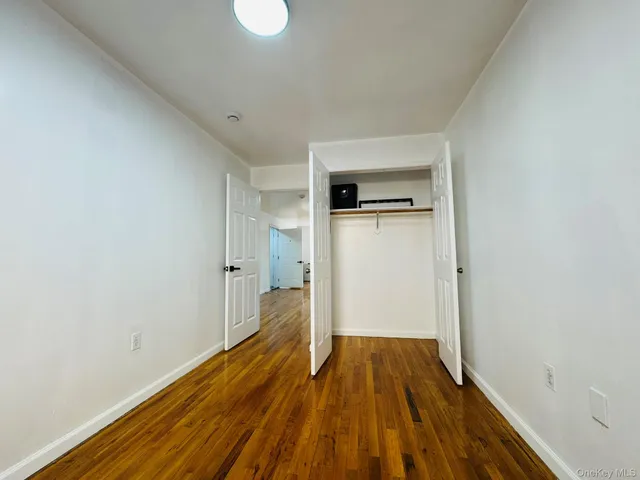 a view of a livingroom with wooden floor and window