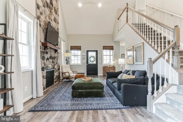 a living room with furniture or couch and a wooden floor