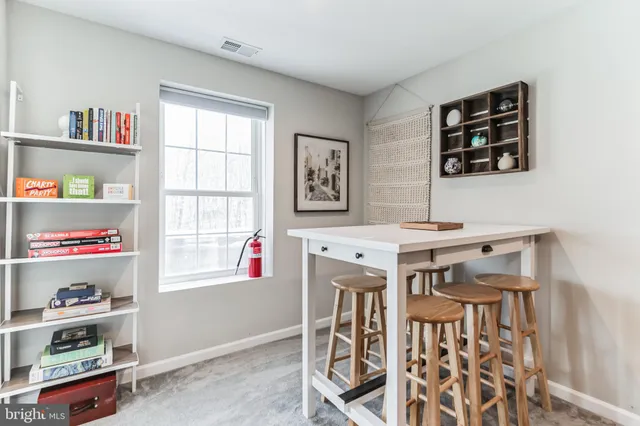 a dining room with furniture and a window