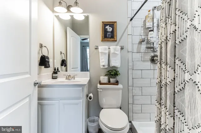 a bathroom with a toilet sink and shower