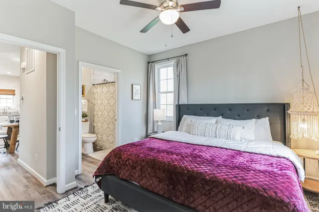 a bedroom with a large bed and a chandelier