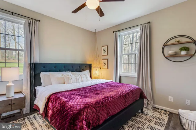 a bed sitting in a bedroom next to a window