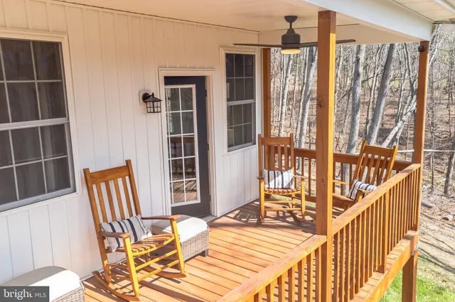 a view of a balcony with chair and the door