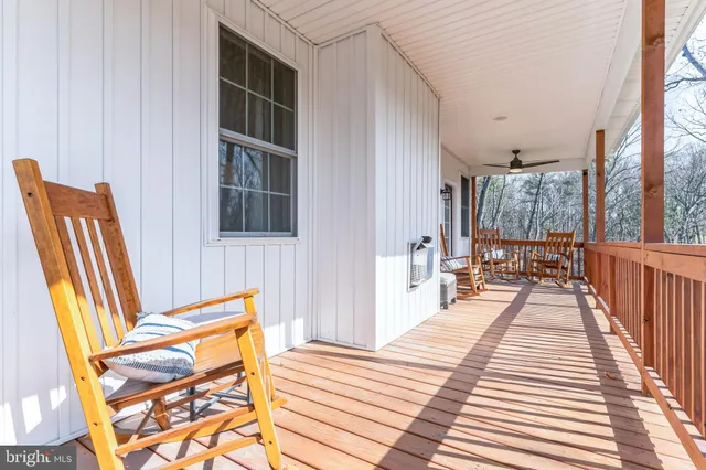 a view of a balcony with wooden floor and furniture