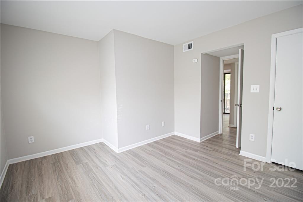 11031 Cedar View Road Charlotte, NC 28226 - Photo 20 of 25 a view of an empty room with wooden floor and closet