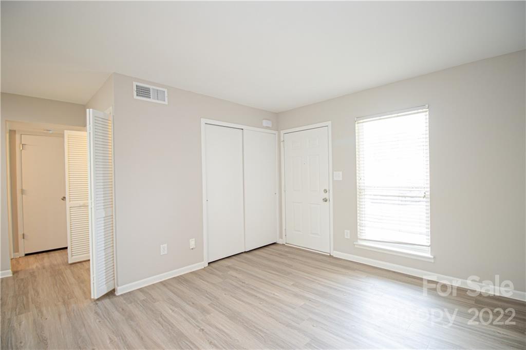 11031 Cedar View Road Charlotte, NC 28226 - Photo 3 of 25 an empty room with wooden floor and windows