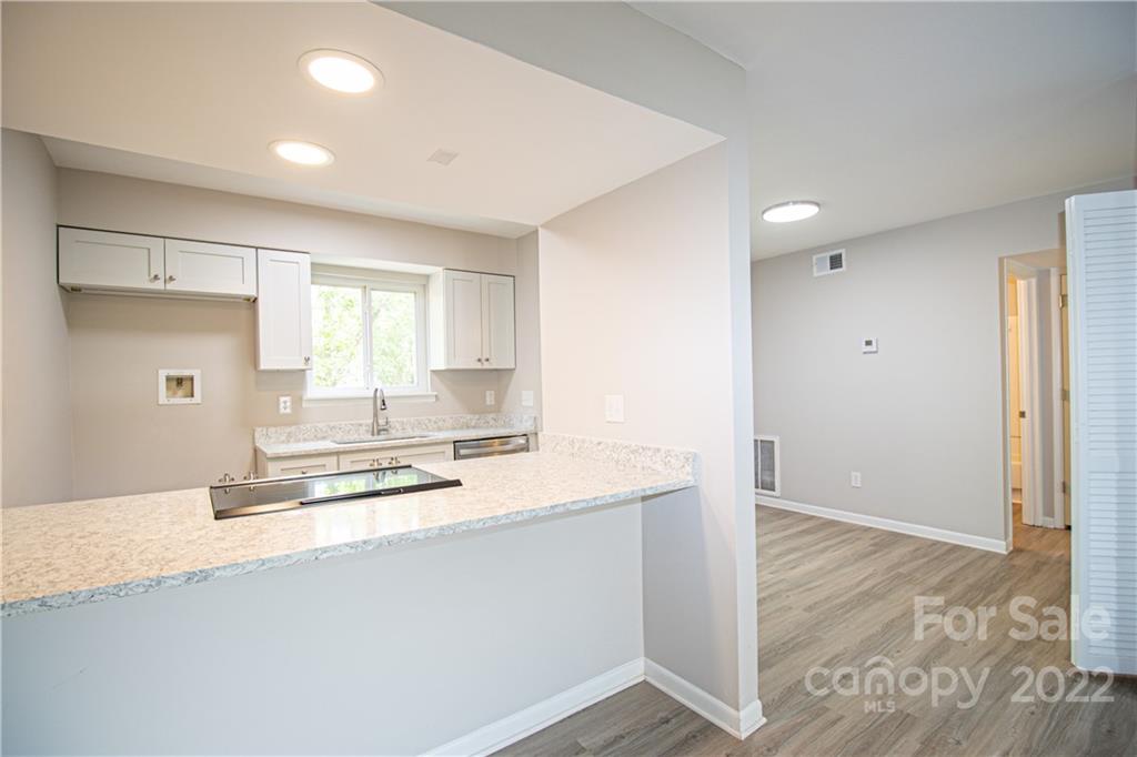 11031 Cedar View Road Charlotte, NC 28226 - Photo 5 of 25 a kitchen with kitchen island white cabinets appliances and a counter top space
