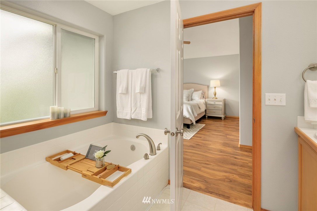 6128 Southeast 3rd Place Renton, WA 98059 - Photo 22 of 28 a bathroom with a tub and a view of living room
