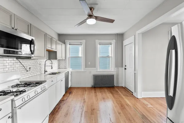 a kitchen with stainless steel appliances a stove a sink and a refrigerator