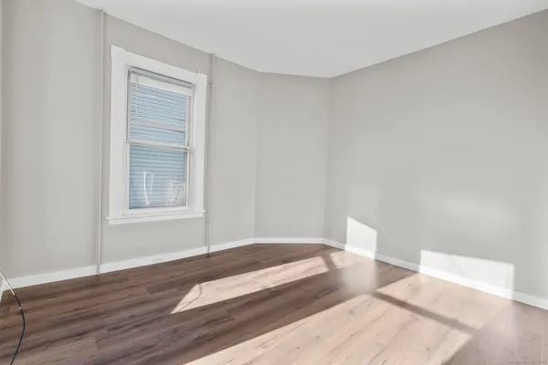 a spacious bedroom with a bed and a window