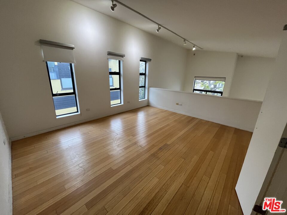 320 Indiana Avenue, Unit A Venice, CA 90291 - Photo 21 of 24 an empty room with wooden floor and windows