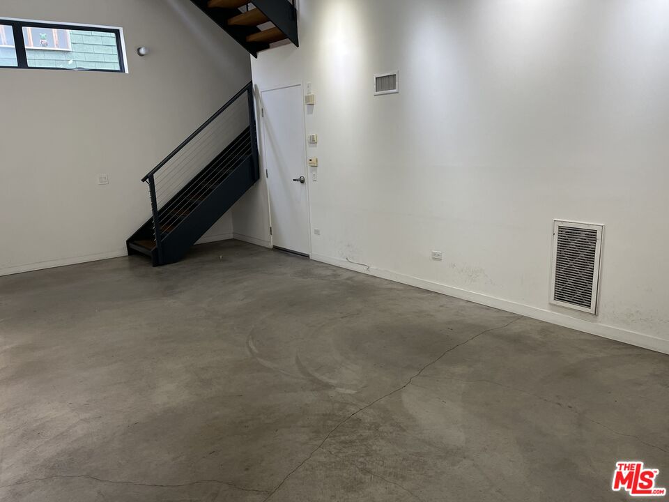 320 Indiana Avenue, Unit A Venice, CA 90291 - Photo 5 of 24 an empty room with staircase and white walls
