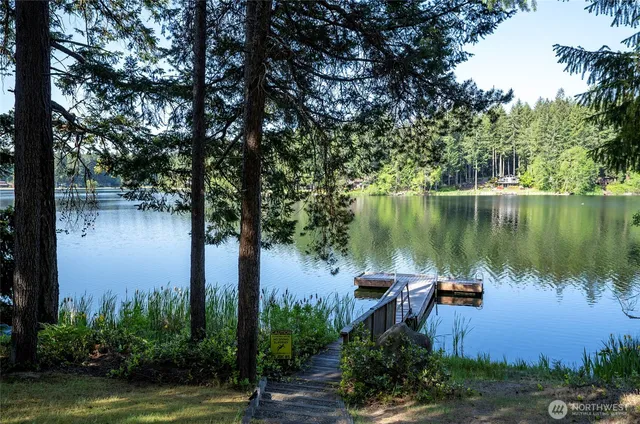 a view of a lake with a house in background