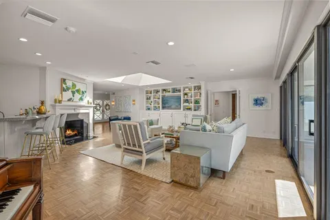 a living room with fireplace furniture and a flat screen tv