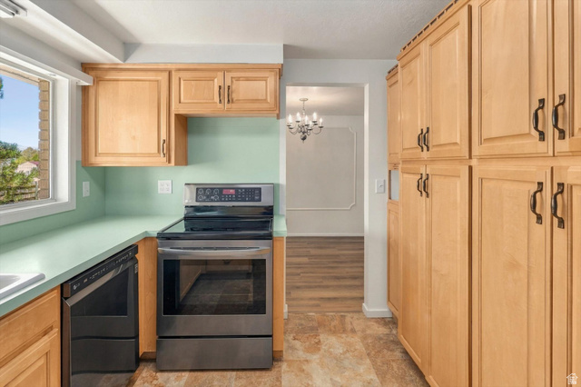 15295 North 5400th Street West Riverside, UT 84334 - Photo 12 of 54 Kitchen featuring light wood cabinetry, light green countertops, and stainless steel appliances