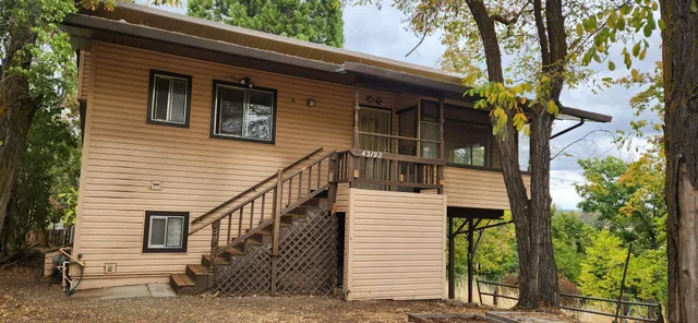 a view of house with a window and wooden fence