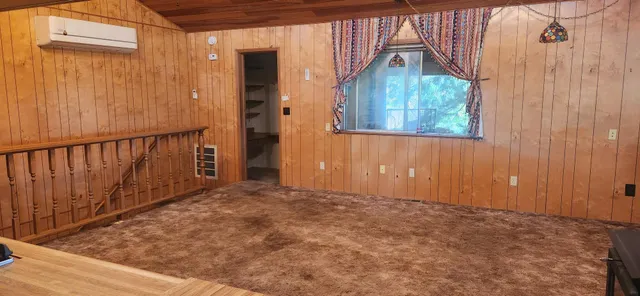 a kitchen with a stove and a wooden floor