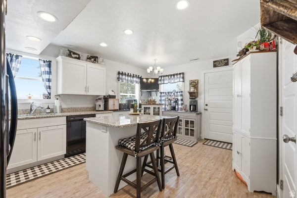 391 South 440th Street West Preston, ID 83263 - Photo 7 of 28 Kitchen featuring light wood-finish flooring, white cabinetry, recessed lighting, and a center island with a granite-style countertop