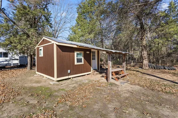 a view of backyard with deck and trees