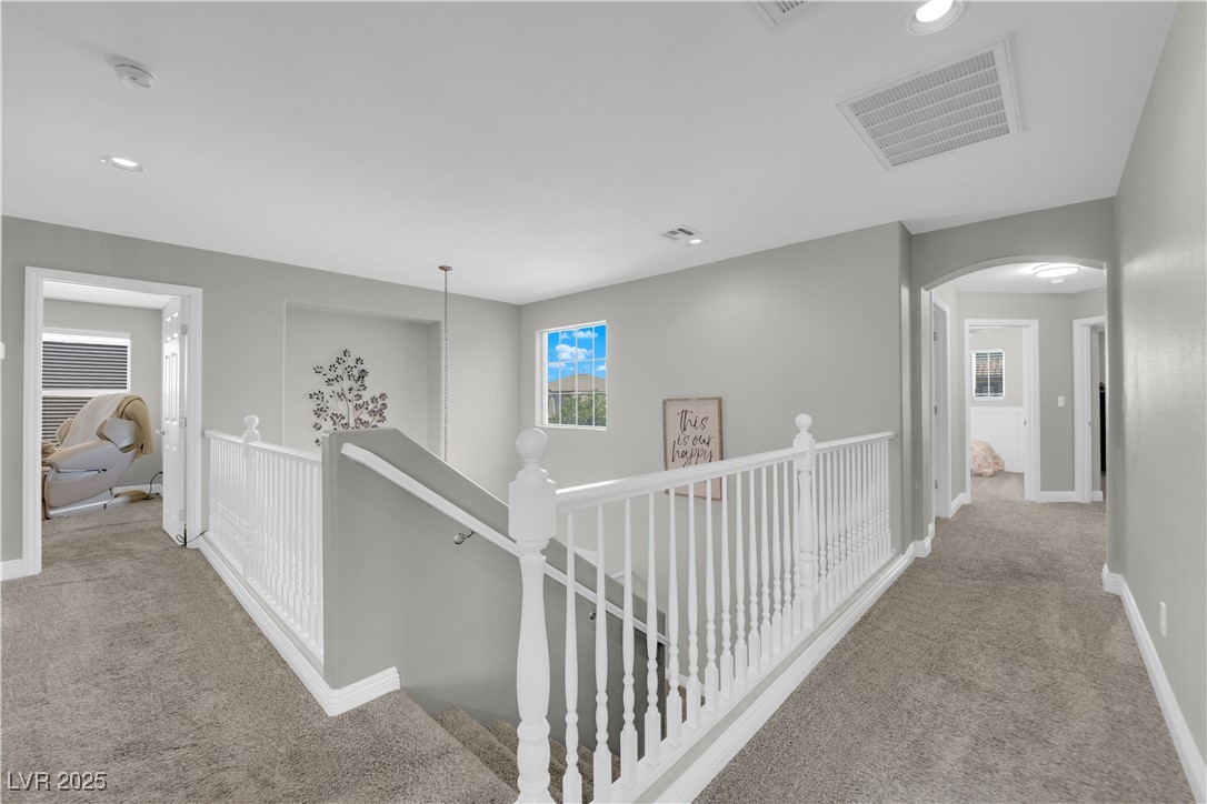 9005 Rendon Street Las Vegas, NV 89143 - Photo 30 of 51 Hallway with light colored carpet, recessed lighting, an upstairs landing, and arched walkways