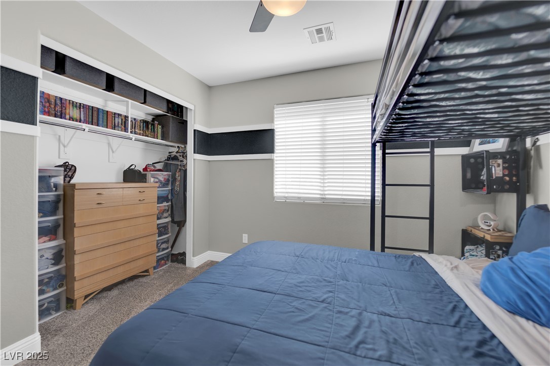 9005 Rendon Street Las Vegas, NV 89143 - Photo 33 of 51 Bedroom featuring carpet flooring, a closet, and a ceiling fan