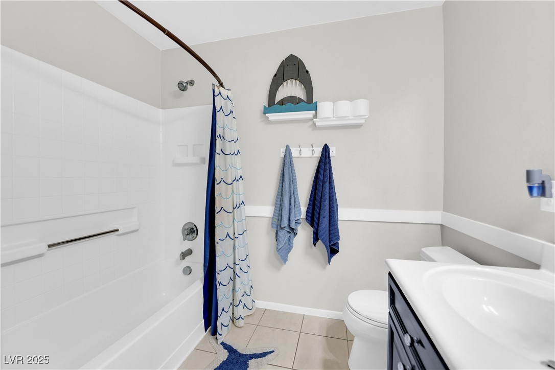 9005 Rendon Street Las Vegas, NV 89143 - Photo 35 of 51 Full bath with shower / bathtub combination with curtain, light tile patterned floors, and vanity