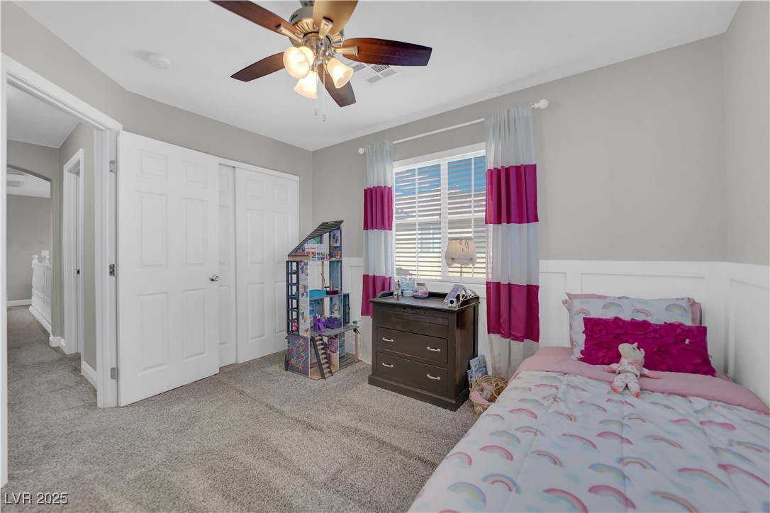 9005 Rendon Street Las Vegas, NV 89143 - Photo 39 of 51 Bedroom featuring light carpet, arched walkways, a closet, and a ceiling fan