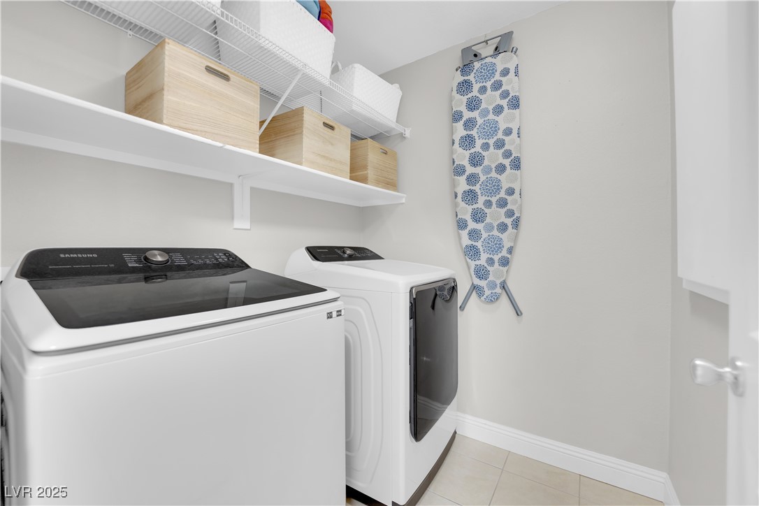 9005 Rendon Street Las Vegas, NV 89143 - Photo 40 of 51 Laundry area with light tile patterned flooring and washer and clothes dryer