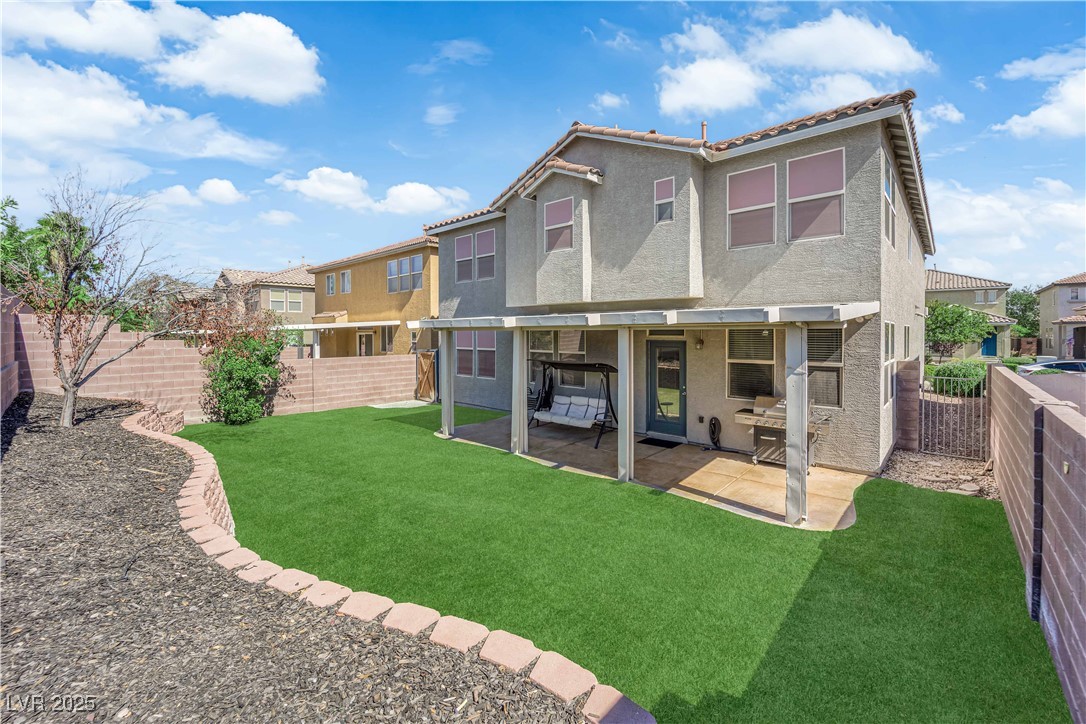 9005 Rendon Street Las Vegas, NV 89143 - Photo 42 of 51 Rear view of property with a fenced backyard, stucco siding, a patio, and a tiled roof