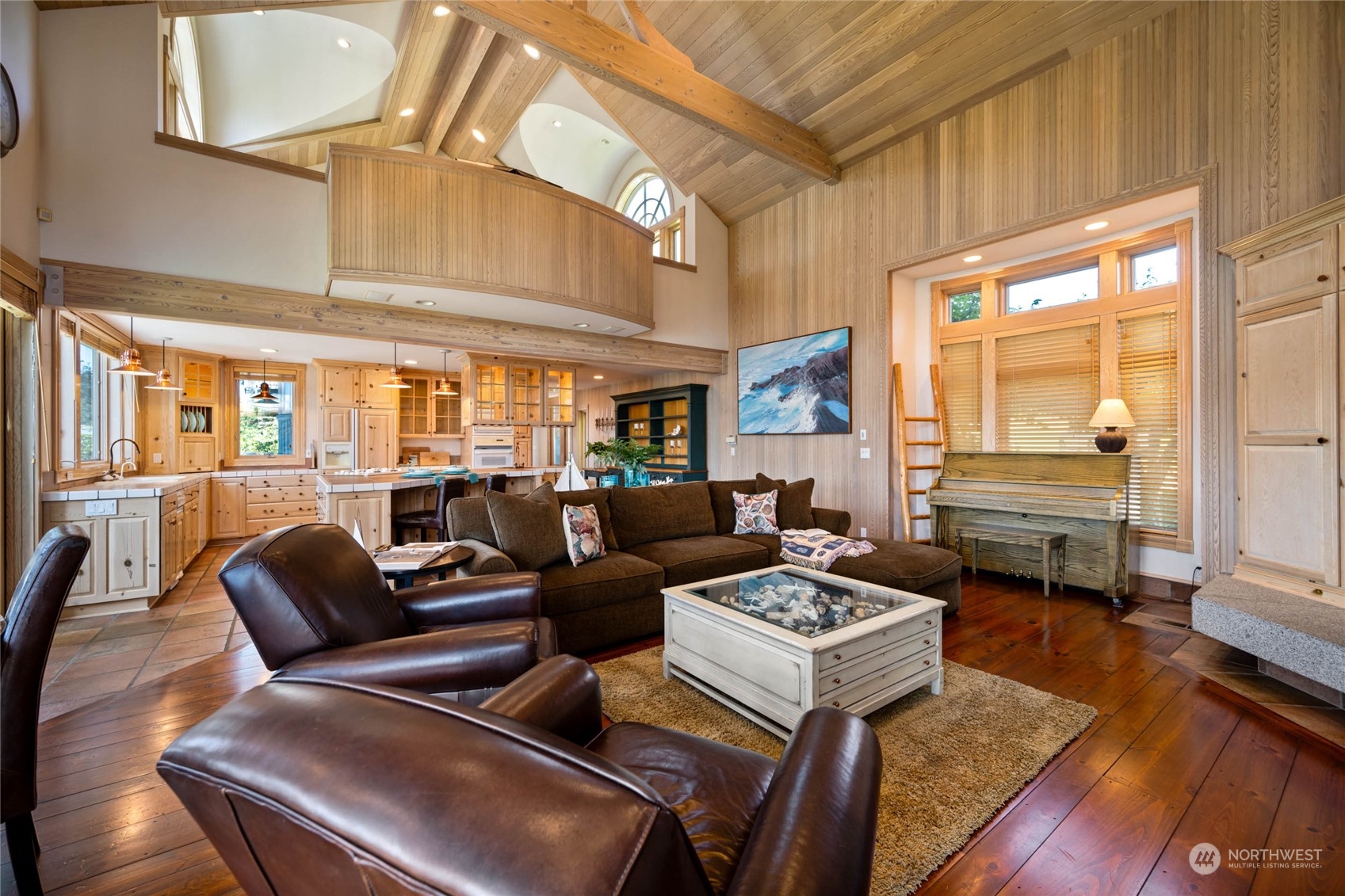15215 Gibralter Road Anacortes, WA 98221 - Photo 12 of 40 a living room with furniture floor to ceiling window and wooden floor