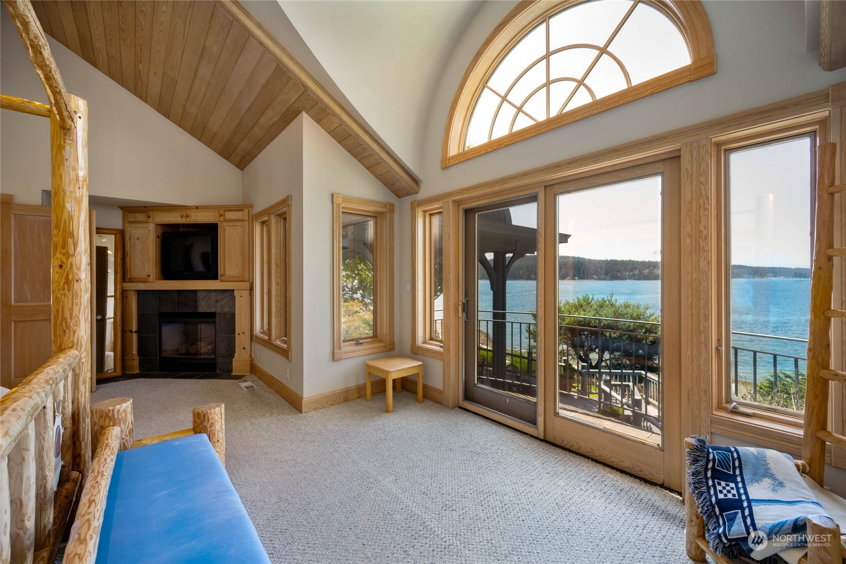 15215 Gibralter Road Anacortes, WA 98221 - Photo 24 of 40 a living room with furniture and a floor to ceiling window