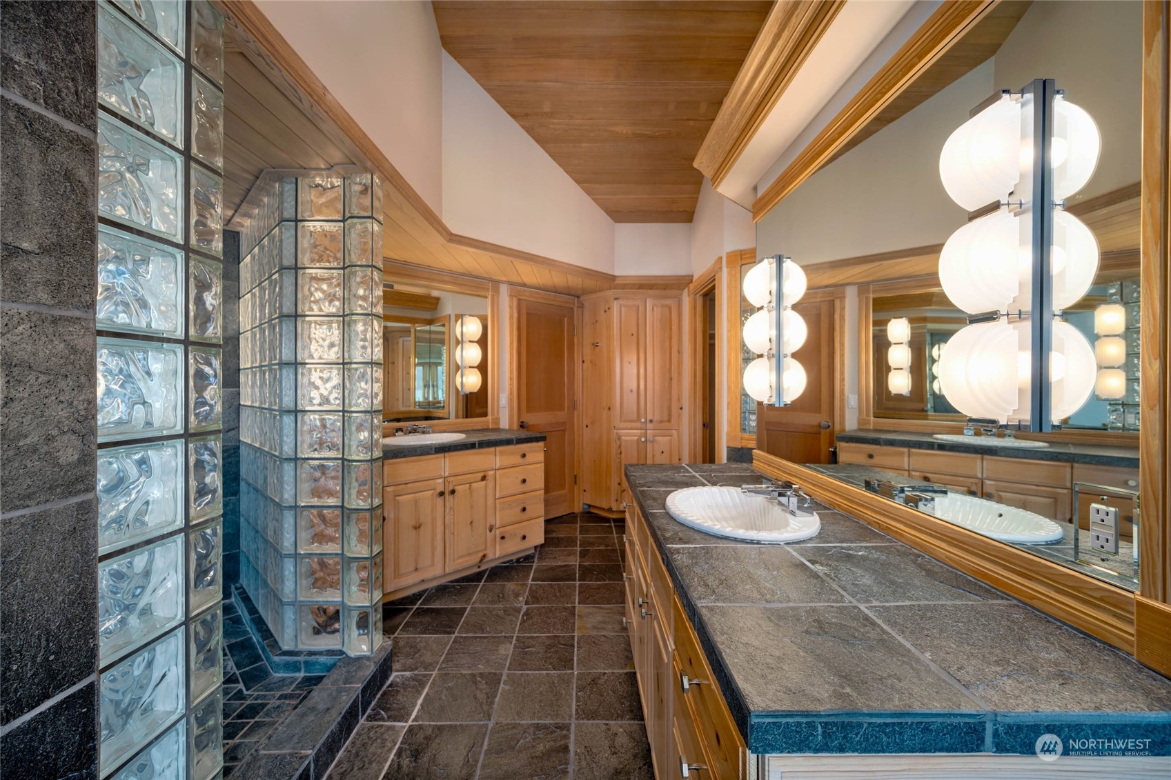 15215 Gibralter Road Anacortes, WA 98221 - Photo 26 of 40 a bathroom with a double vanity sink and a mirror
