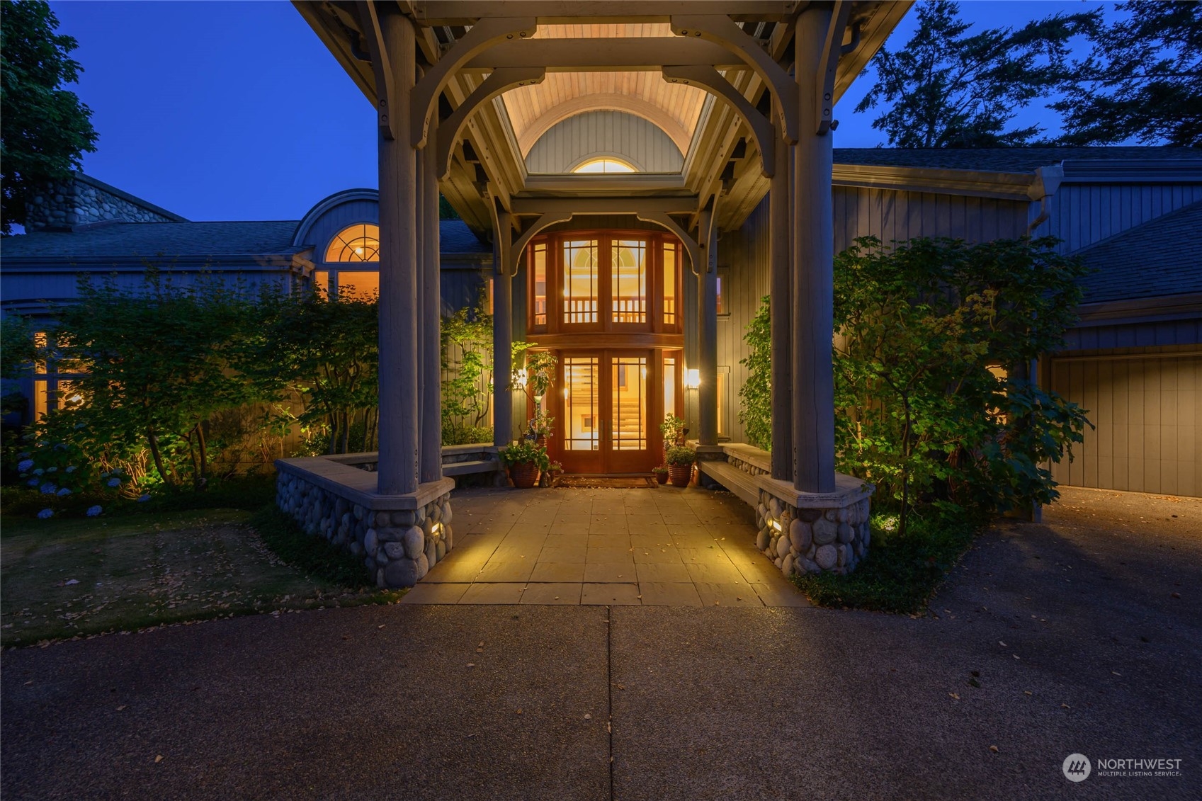 15215 Gibralter Road Anacortes, WA 98221 - Photo 35 of 40 a view of a house with brick walls and a yard