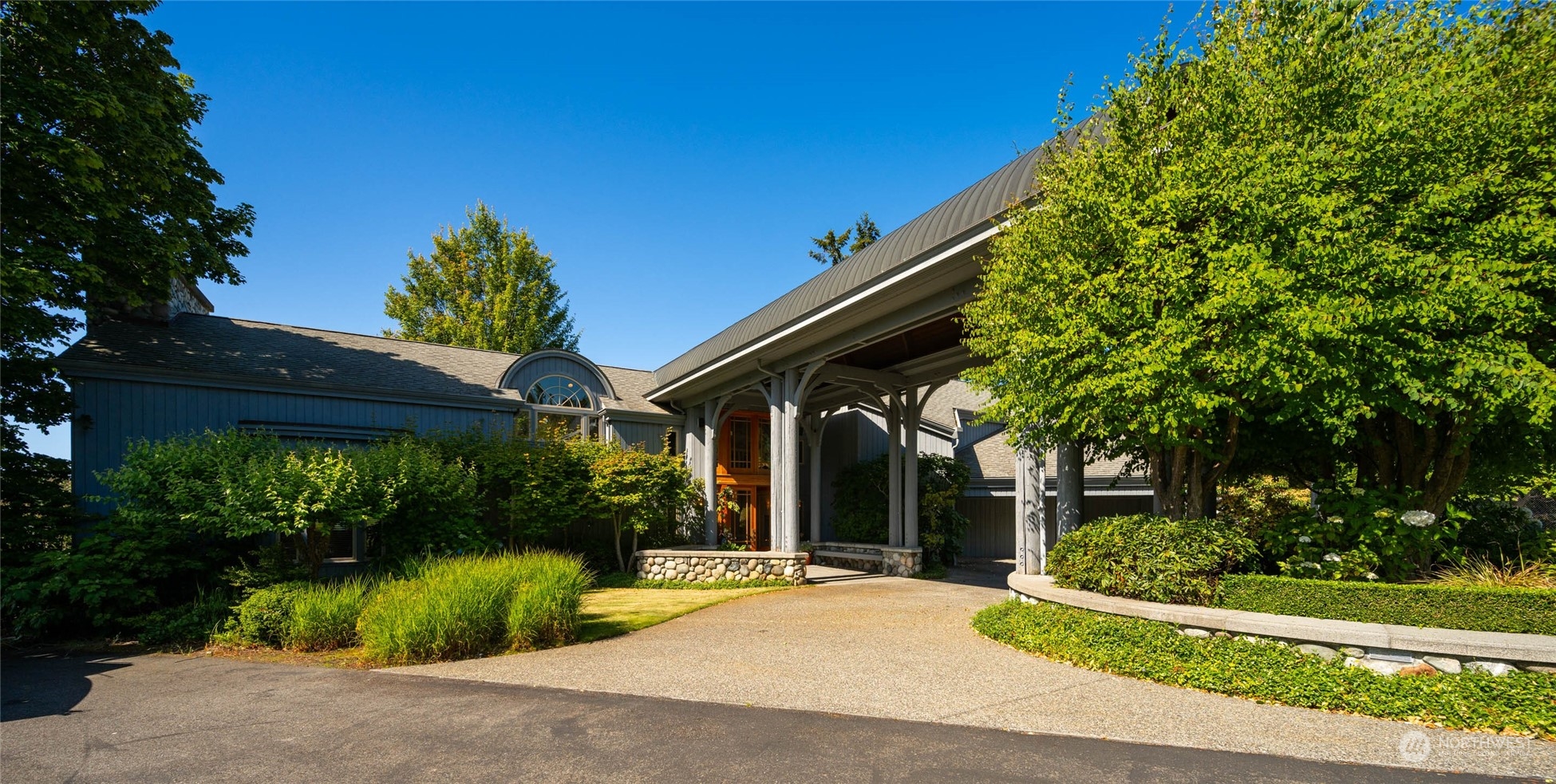 15215 Gibralter Road Anacortes, WA 98221 - Photo 8 of 40 a view of a patio with table and chairs and potted plants