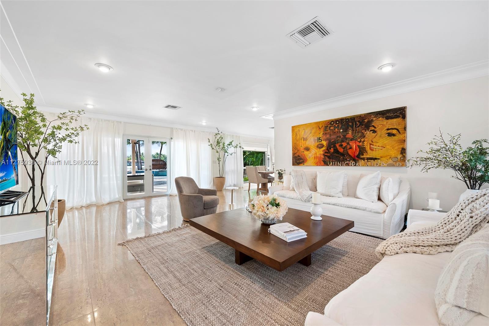 940 88th Street Surfside, FL 33154 - Photo 12 of 38 a living room with furniture and a flat screen tv