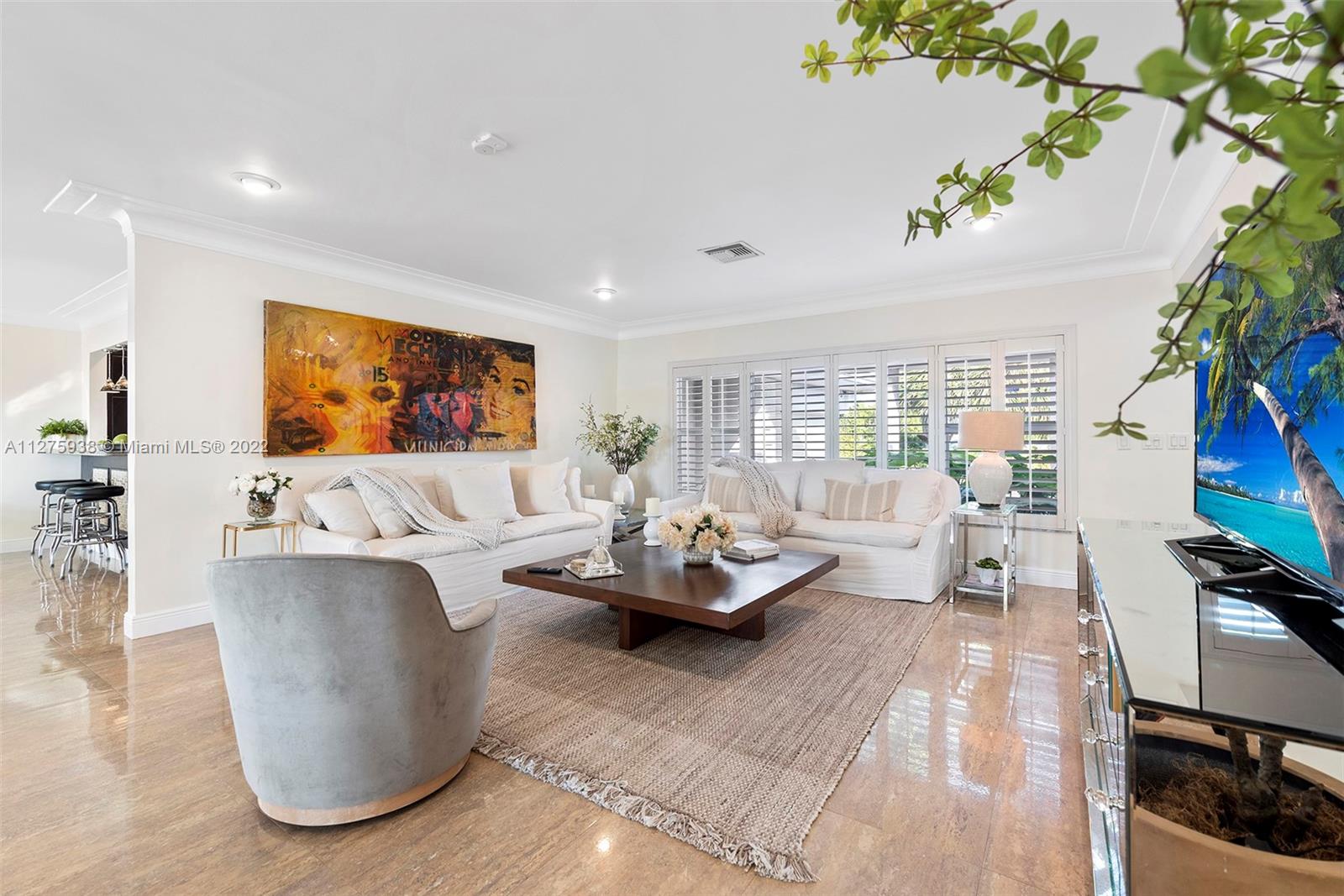 940 88th Street Surfside, FL 33154 - Photo 13 of 38 a living room with furniture and a flat screen tv