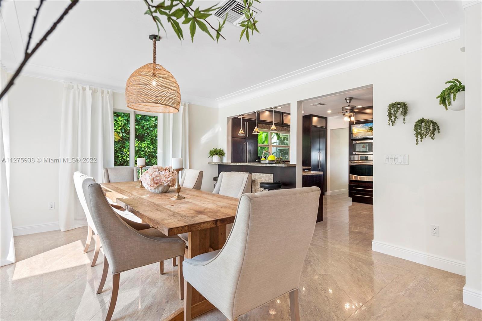 940 88th Street Surfside, FL 33154 - Photo 15 of 38 a view of a dining room with furniture a livingroom and chandelier