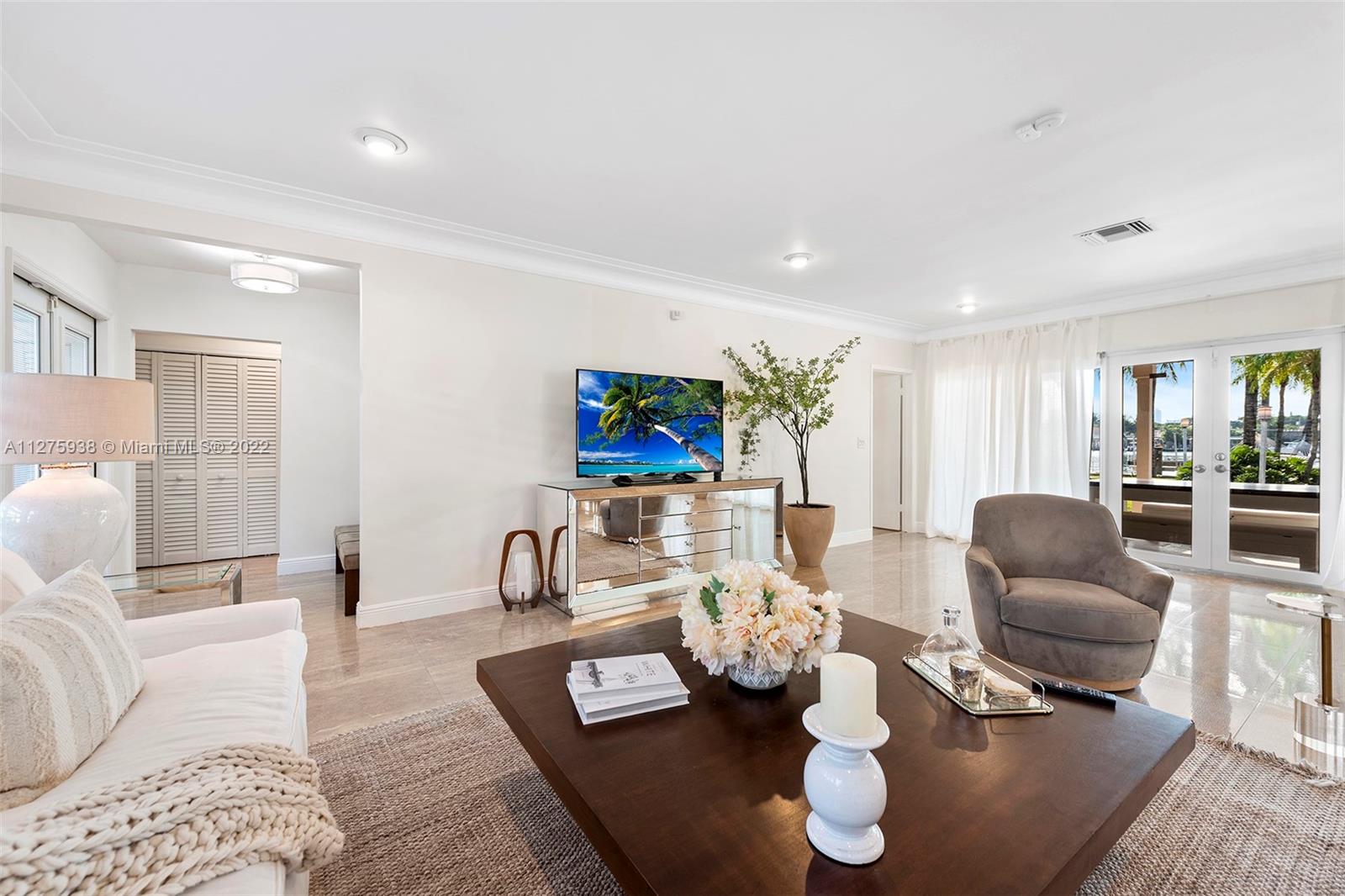 940 88th Street Surfside, FL 33154 - Photo 16 of 38 a living room with furniture and a flat screen tv