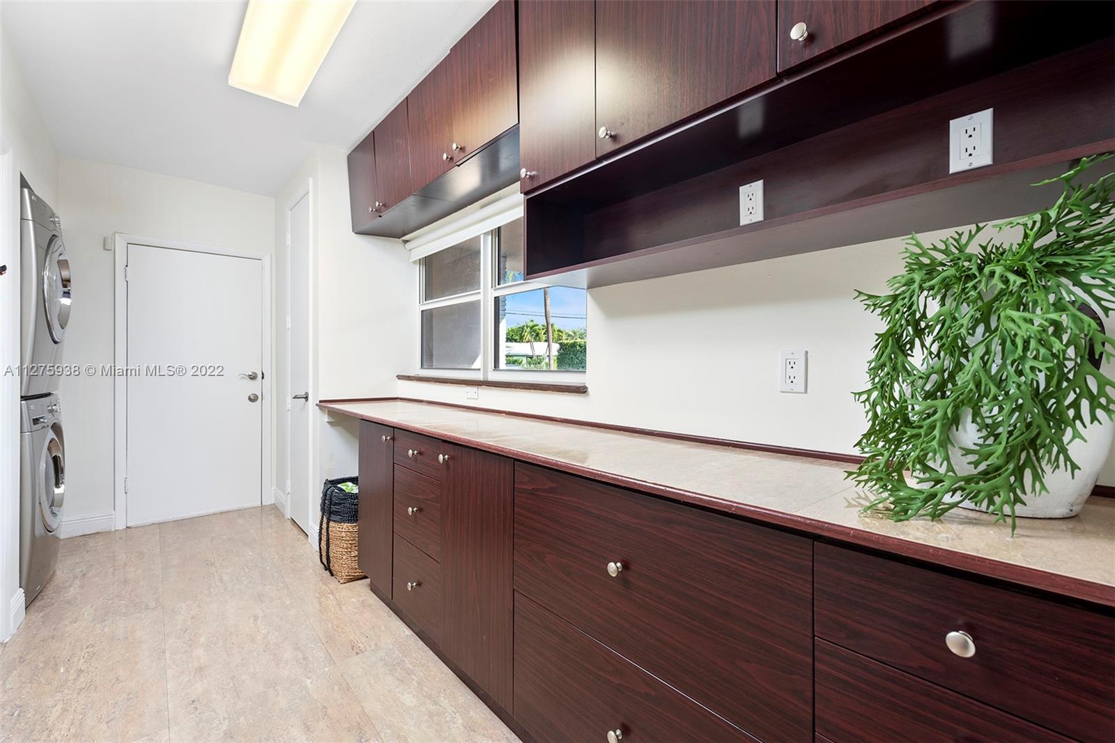 940 88th Street Surfside, FL 33154 - Photo 19 of 38 a bathroom with a sink and a mirror