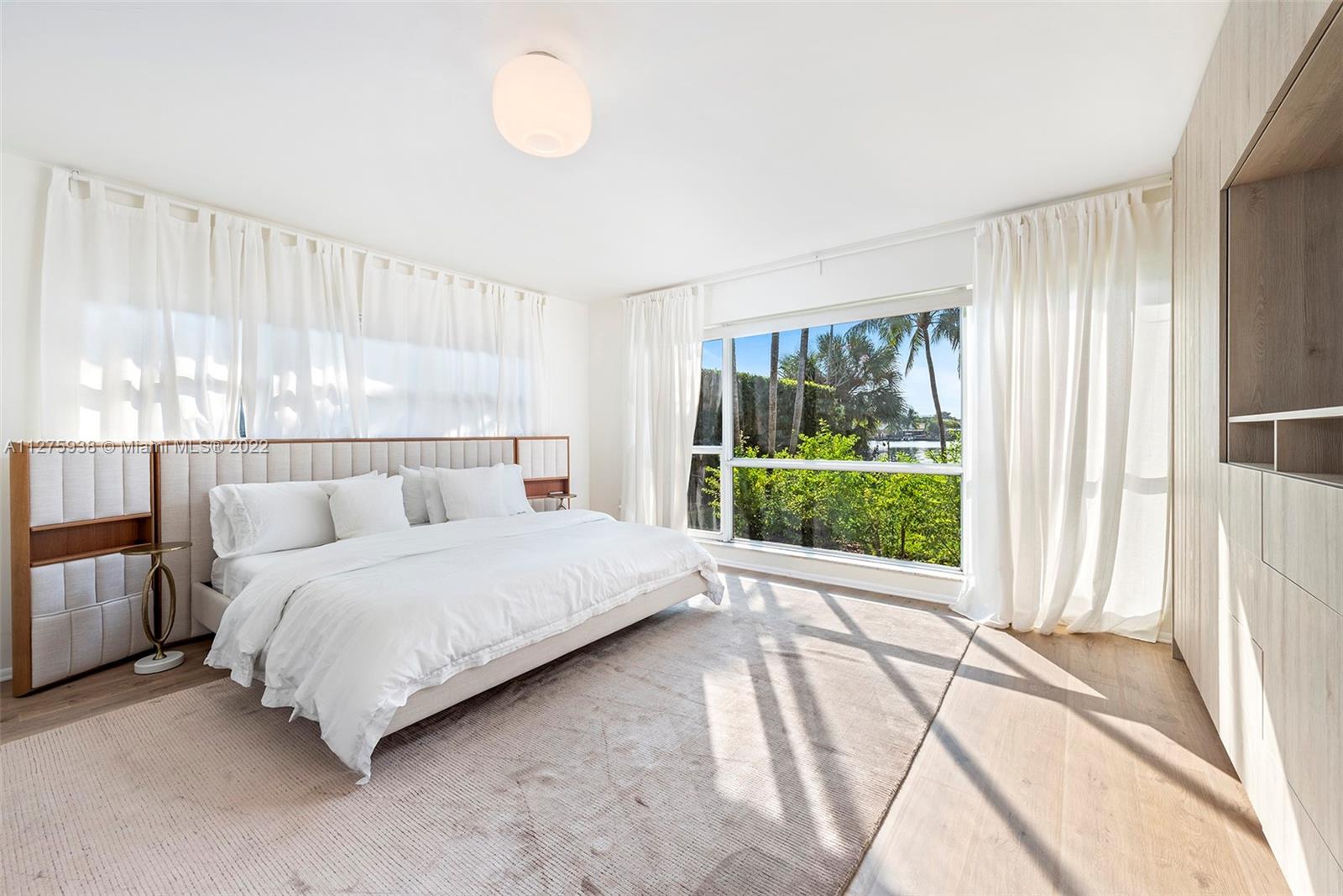 940 88th Street Surfside, FL 33154 - Photo 23 of 38 a bedroom with a bed and a large window