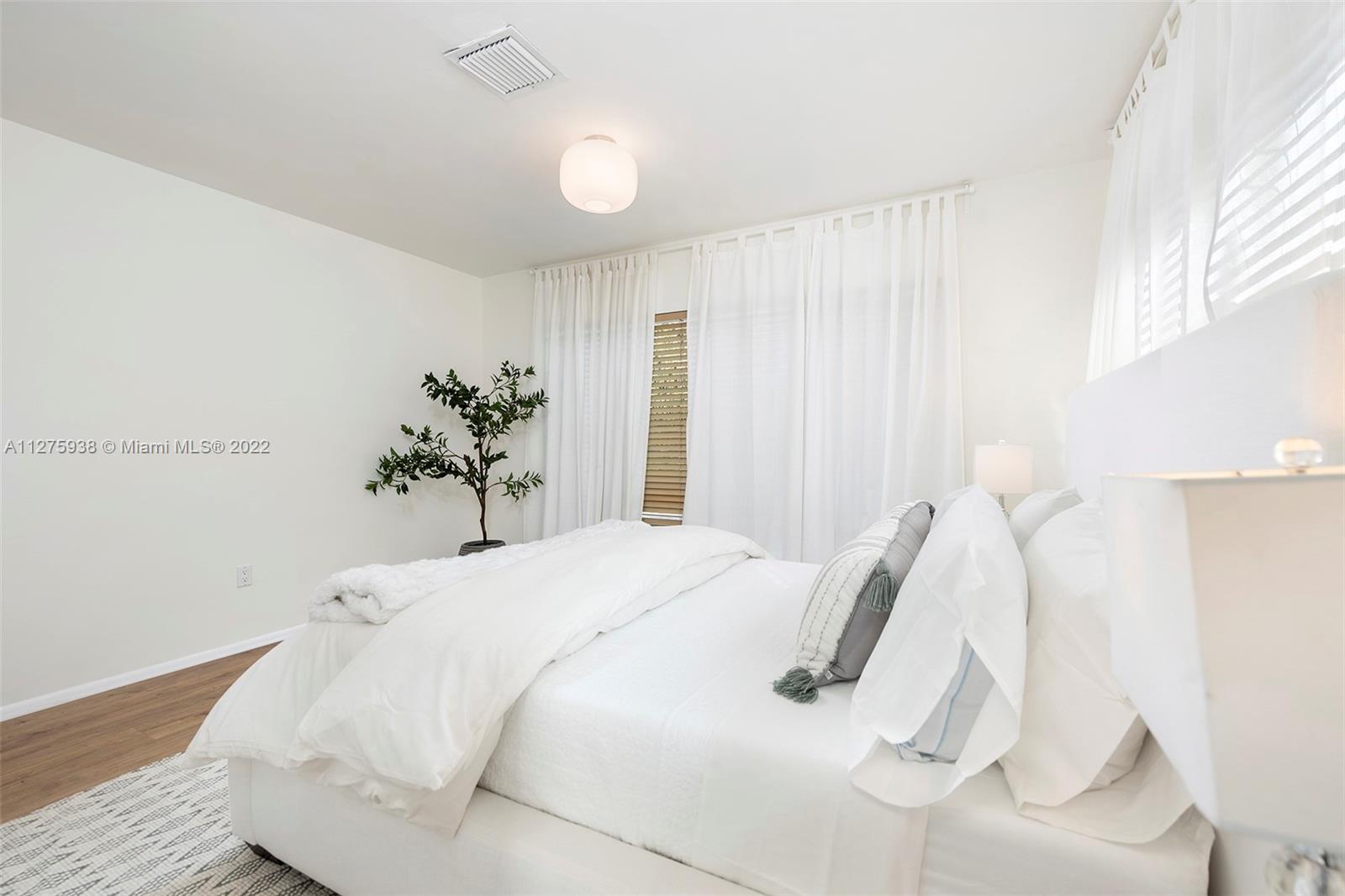 940 88th Street Surfside, FL 33154 - Photo 24 of 38 a bedroom with a bed and painting on the wall