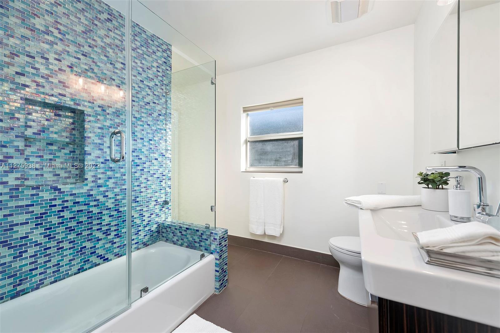 940 88th Street Surfside, FL 33154 - Photo 25 of 38 a bathroom with a bathtub and sink