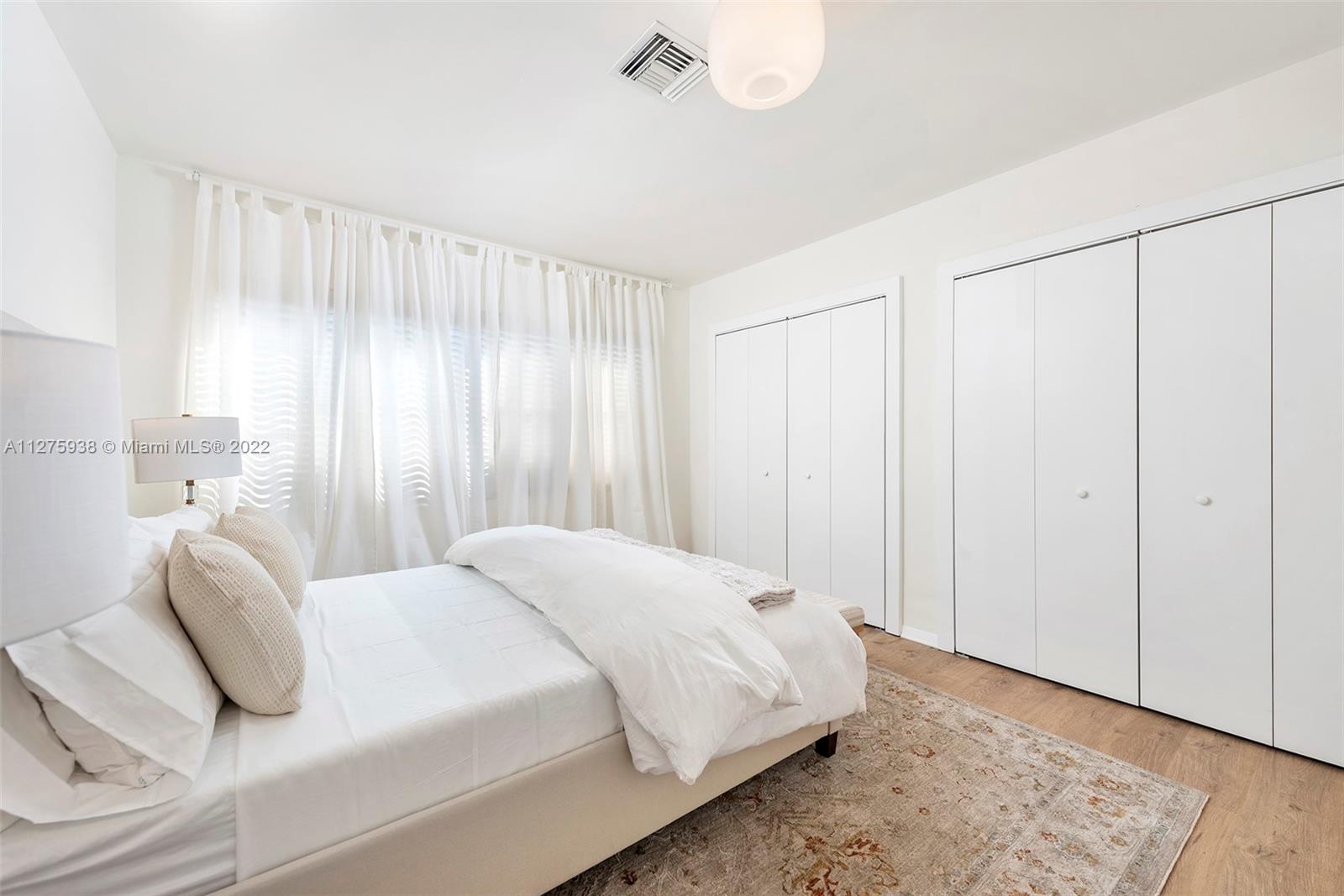 940 88th Street Surfside, FL 33154 - Photo 26 of 38 a bedroom with a bed and a window