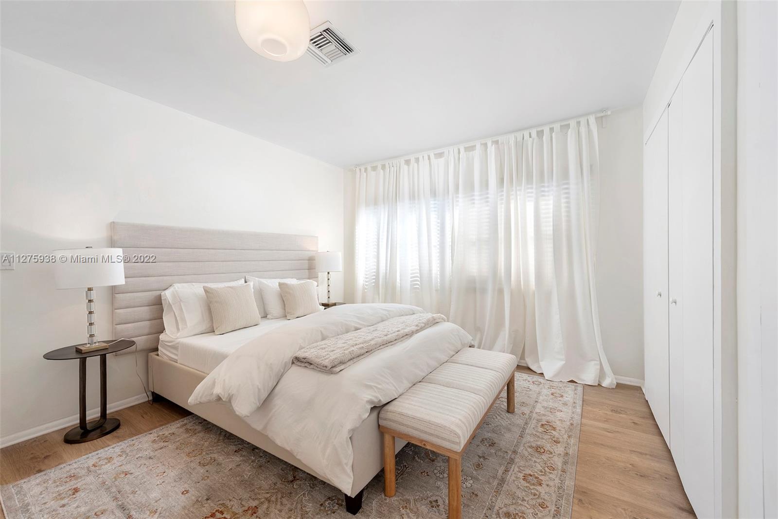 940 88th Street Surfside, FL 33154 - Photo 27 of 38 a bedroom with a bed and a window