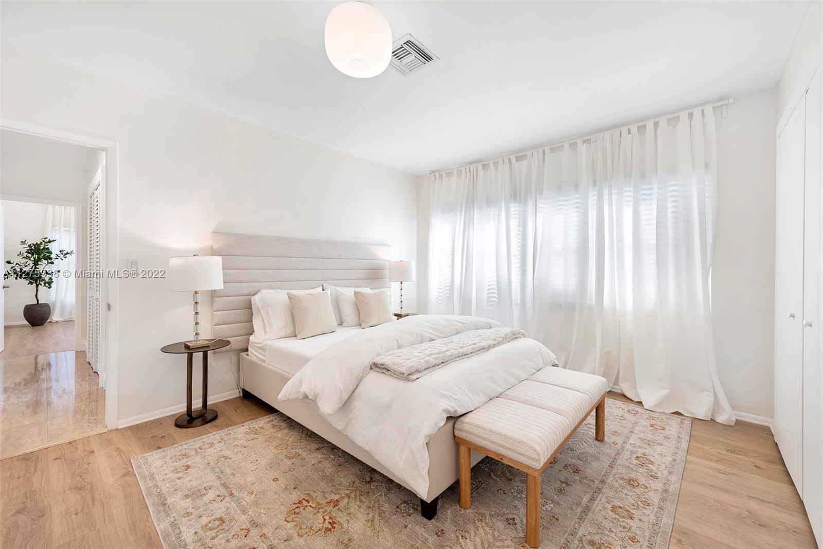 940 88th Street Surfside, FL 33154 - Photo 28 of 38 a bedroom with a bed and lamps